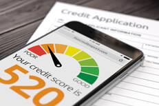 Mobile poor credit score Cell phone with poor credit score showing resting on top of paper credit application