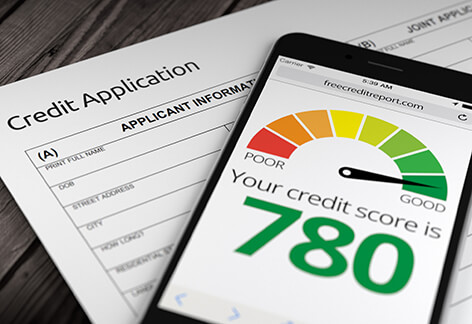 Credit application with good credit Paper credit application on desk with mobile phone showing good credit score of 780