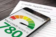 Credit application good credit Paper credit application on wood desk with iPhone showing good credit rating of 780
