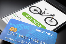 iPhone with credit card iPhone showing buy now button with blue credit card lying on screen