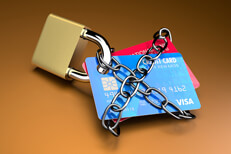 Credit lock orange background Credit cards padlocked and chained on orange background
