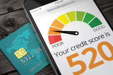 Cell phone showing poor credit score Cell phone screen showing poor credit rating on top of credit card with EMV chip