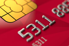 Close up view of red credit card Close up view of red credit card EMV chip and credit card number