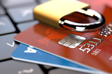 Credit cards on laptop with padlock Credit cards lying on keyboard with padlock