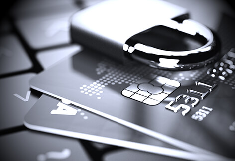 Credit cards with padlock vignette Credit cards on laptop with padlock in black and white with vignette