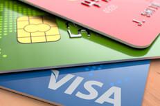 Red Green Blue credit cards Three credit cards in red green and blue on wood desk