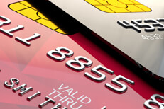 Close up of two shiny credit cards Close up view of shiny red and black credit cards with EMV chips
