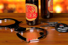 Beer bottles with handcuffs and keys Beer bottles on bar with chrome handcuffs and car keys