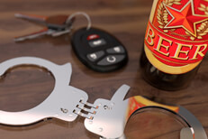 Car keys and hand cuffs Car keys with hand cuffs and a beer bottle sitting on bar free DUI image