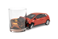 Red car crashed into glass of whiskey Drunk driving concept showing small red car crashed into side of whiskey glass isolated on white