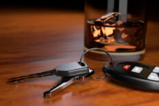 Impared driving concept showing whiskey glass and car keys on bar top