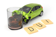 Green car DUI crash DUI accident with wood letters spelling DUI in foreground