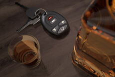 Whiskey shots with car keys Whiskey bottle and shot glasses on wood bar with car keys DUI concept image