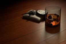 Whiskey glass on bar with wallet and keys Drunk driving concept showing a whiskey glass on bar with wallet and car keys