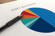 Asset allocation pie chart and pen Paper with asset allocation pie chart overlaid with ballpoint pen on table