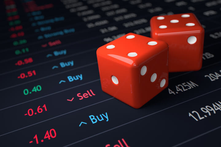 Red dice on stock ticker chart showing stock prices and buy/sell recommendations