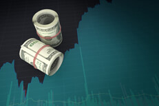Rolls of money on area chart Rolls of U.S. currency on computer screen with stock price area chart