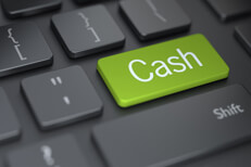 Cash key on keyboard Dark keyboard with large green Cash button concept for putting investments into cash