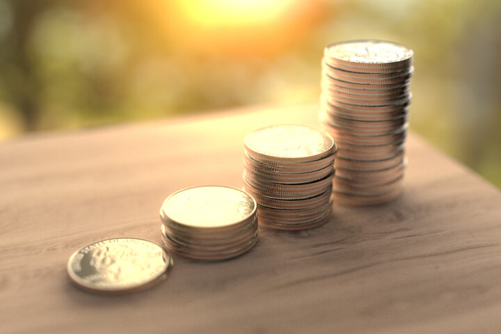 Stack of quarters on table with early morning light