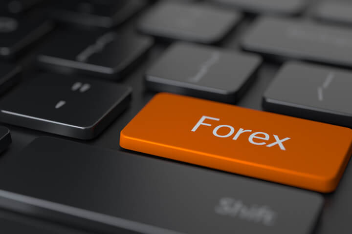 Dark keyboard with large orange Forex key representing online Forex trading and research