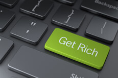 Get rich keyboard key Dark keyboard with large green Get Rich key concept for getting rich or making money online