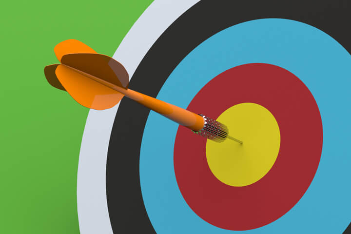 Orange dart hitting target bulls eye with green background