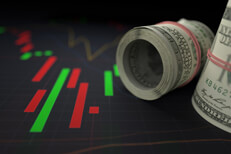 Money rolls on candlestick chart Close up view of rolls of money next to bright stock price candlestick chart