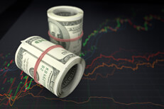 Money rolls and line charts Money rolls sitting on stock price line charts