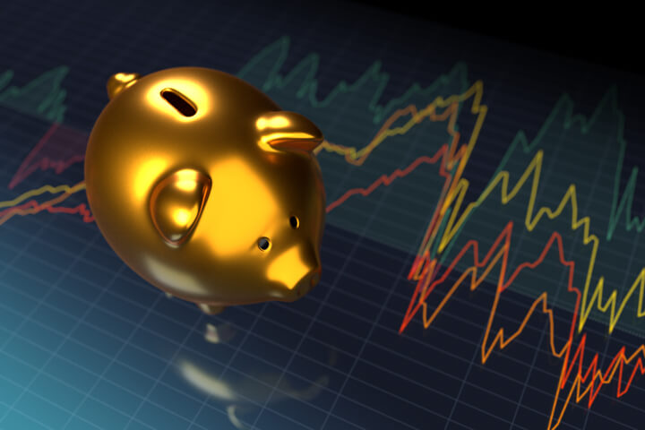 Shiny gold metallic piggy bank on stock and market price line chart with glossy reflection