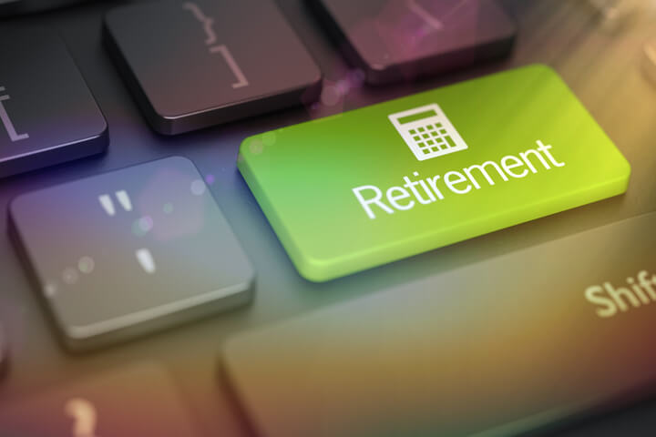 Laptop keyboard with large green Retirement key and calculator icon with lens flare and overlay