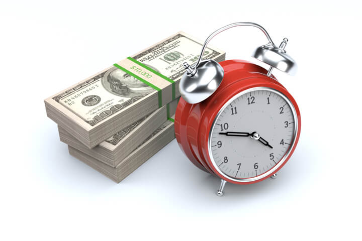 Red alarm clock and stacks of money on white background concept for time value of money, time is money, or compound interest