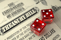 Treasury bill with dice Old U.S. Treasury Bill with two dice concept for risk of investing in government treasuries