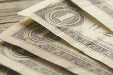 Close up of fanned dollar bills Close up free photo of dollar bills fanned out on wood background