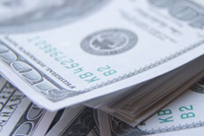 Messy pile of money Large stack of $100 bills scattered
