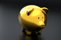 Gold piggy bank Metallic gold piggy bank isolated on dark background