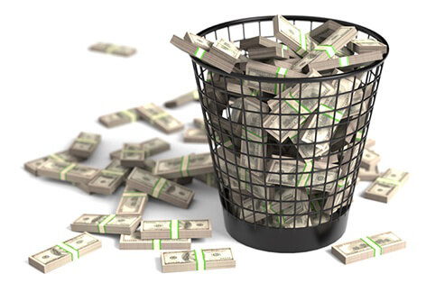Trash can full of money Bundles of cash thrown in trash can concept for waste or mismanagement of funds