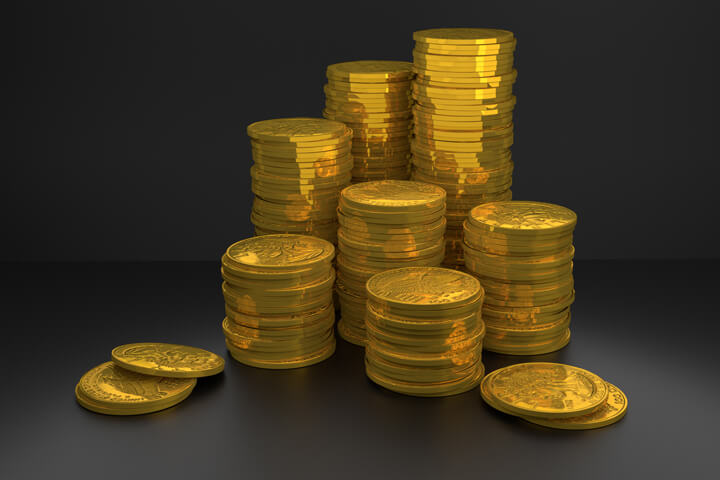 Free image of stacks of 100 dollar U.S. gold coins on dark background