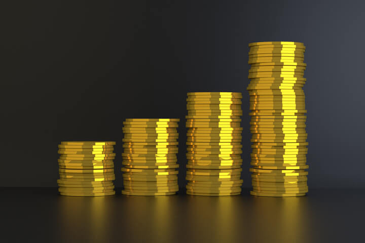 Column chart of gold coins representing growth, increase, returns over time, or investment