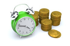 Green clock with gold coins Concept image of green clock with stacks of gold U.S. coins