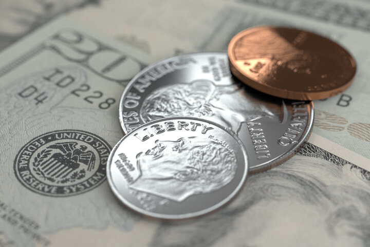 U.S. coins on twenty dollar bills