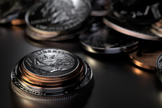 Coin stack and random U.S. coins stacked in foreground with random coins piled in background