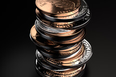 Coin stack Large vertical stack of shiny U.S. coins on black background