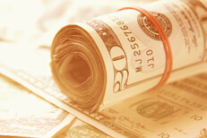 Roll of twenty dollar bills summer light Roll of twenty dollar bills on random stack of bills with bright summer light