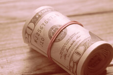 Roll of twenty dollar bills lighting effect Large roll of twenty dollar bills on wood background with instagram western lighting