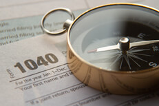 Tax navigation concept image Concept image of 1040 tax form and navigation compass illustrating tax help or advice