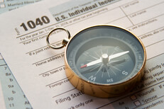 Tax help concept photo Tax help concept photo showing IRS form 1040 with navigational compass
