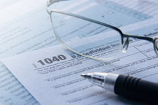 IRS form 1040 with reading glasses IRS form 1040 tax forms with reading glasses and ballpoint pen tax filing concept photo