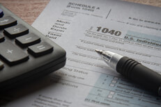 IRS form 1040 pen and calculator Calculator and ballpoint pen on IRS form 1040 paperwork