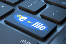 IRS e-file keyboard key Laptop keyboard with IRS e-file key replacing enter key concept for filing taxes online