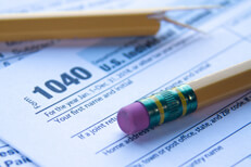 IRS 1040 form with broken pencil Sunlight photo of IRS form 1040 with broken pencil concept for tax time frustrations